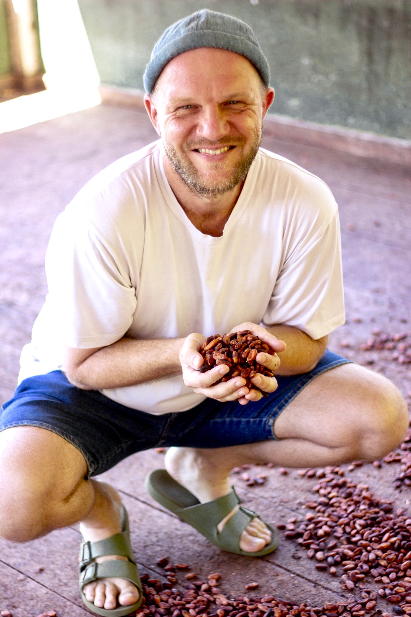 Mike Polarny holds cacao beans in both hands.
